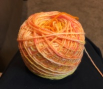 Orangesicle on a base of Franklin Valley Cone Yarns - Superwash